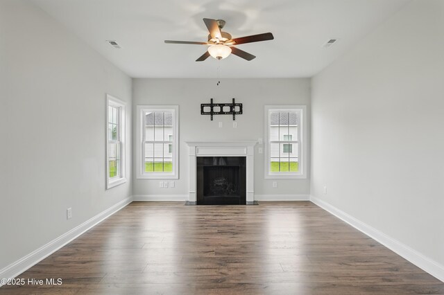 33 Chippewa Ln, Rocky Point, NC 28457 - unfurnished living room featuring ceiling fan, healthy amount of natural light, dark wood-type flooring, and a fireplace