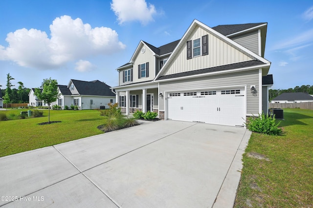 33 Chippewa Ln, Rocky Point, NC 28457 - traditional home with board and batten siding, central air condition unit, concrete driveway, and a front lawn