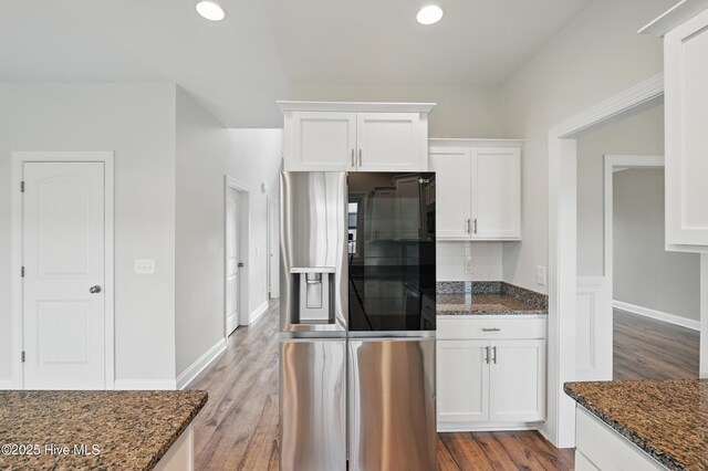 33 Chippewa Ln, Rocky Point, NC 28457 - kitchen featuring stainless steel refrigerator with ice dispenser, dark stone countertops, white cabinetry, wood finished floors, and recessed lighting