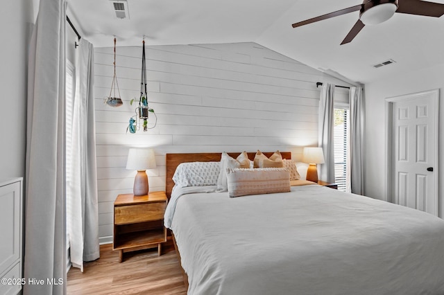 113 Sunshine Ln Unit C8, Winterville, NC 28590 - bedroom featuring lofted ceiling, light wood finished floors, wood walls, and a ceiling fan