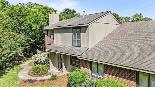 113 Sunshine Ln Unit C8, Winterville, NC 28590 - view of property exterior with brick siding, a chimney, and a shingled roof