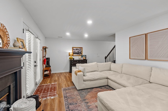 113 Sunshine Ln Unit C8, Winterville, NC 28590 - living room with a glass covered fireplace, light wood-style floors, recessed lighting, stairs, and baseboards