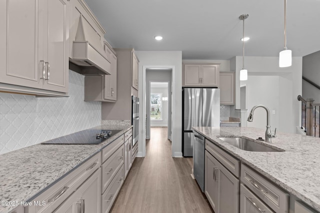 81 Eagle Claw Dr, Calabash, NC 28467 - kitchen featuring a sink, appliances with stainless steel finishes, wood finished floors, custom exhaust hood, and decorative light fixtures