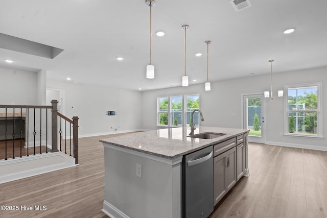 81 Eagle Claw Dr, Calabash, NC 28467 - kitchen featuring dishwasher, a sink, light wood-style flooring, light stone counters, and open floor plan