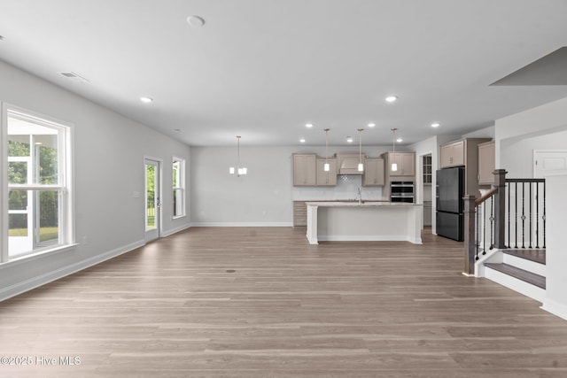 81 Eagle Claw Dr, Calabash, NC 28467 - unfurnished living room with recessed lighting, light wood-style flooring, baseboards, and stairs
