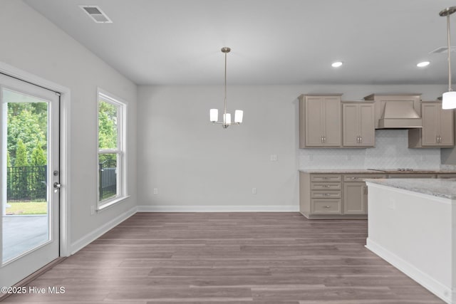 81 Eagle Claw Dr, Calabash, NC 28467 - kitchen featuring custom exhaust hood, backsplash, wood finished floors, pendant lighting, and recessed lighting