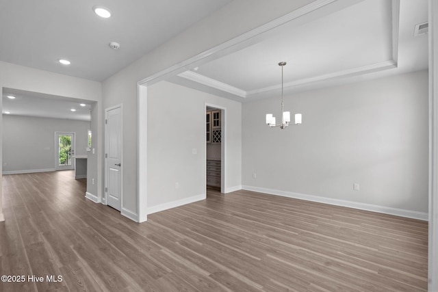 81 Eagle Claw Dr, Calabash, NC 28467 - empty room featuring baseboards, recessed lighting, a chandelier, a tray ceiling, and wood finished floors