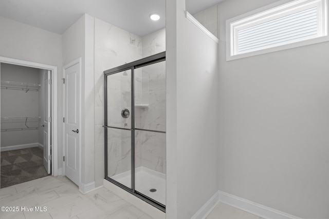 81 Eagle Claw Dr, Calabash, NC 28467 - bathroom featuring a shower stall, marble finish floors, a walk in closet, and baseboards