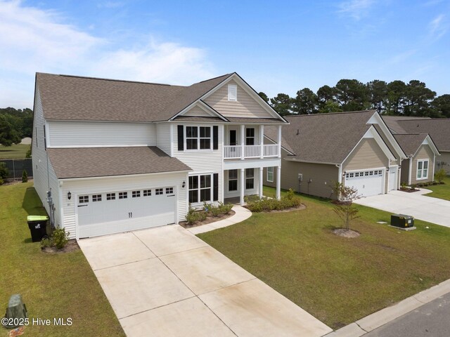 81 Eagle Claw Dr, Calabash, NC 28467 - traditional-style home featuring concrete driveway, a balcony, a front lawn, a shingled roof, and a garage