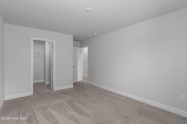 81 Eagle Claw Dr, Calabash, NC 28467 - unfurnished bedroom with a walk in closet, carpet floors, a closet, and baseboards