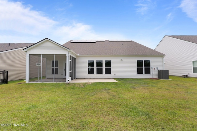 81 Eagle Claw Dr, Calabash, NC 28467 - back of property featuring a patio area, roof mounted solar panels, a lawn, and roof with shingles