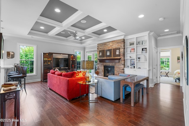 310 White Swan Ct, Wilmington, NC 28412 - living area featuring a stone fireplace, ornamental molding, baseboards, dark wood-type flooring, and healthy amount of natural light