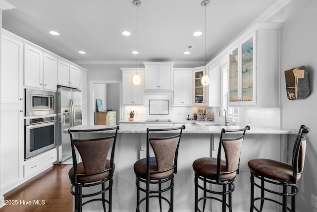 310 White Swan Ct, Wilmington, NC 28412 - kitchen featuring stainless steel appliances, crown molding, glass insert cabinets, white cabinetry, and recessed lighting