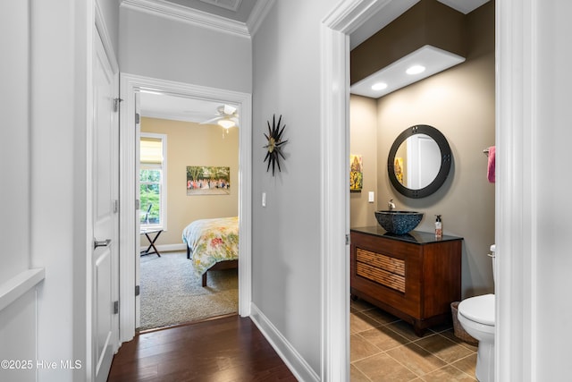 310 White Swan Ct, Wilmington, NC 28412 - hallway featuring ornamental molding, a sink, and baseboards