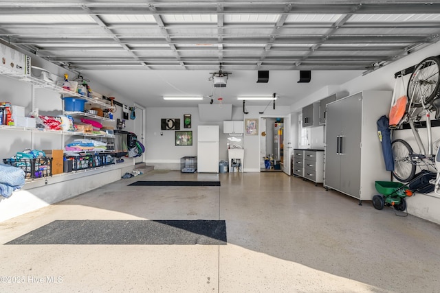 310 White Swan Ct, Wilmington, NC 28412 - garage with freestanding refrigerator, a garage door opener, and a sink
