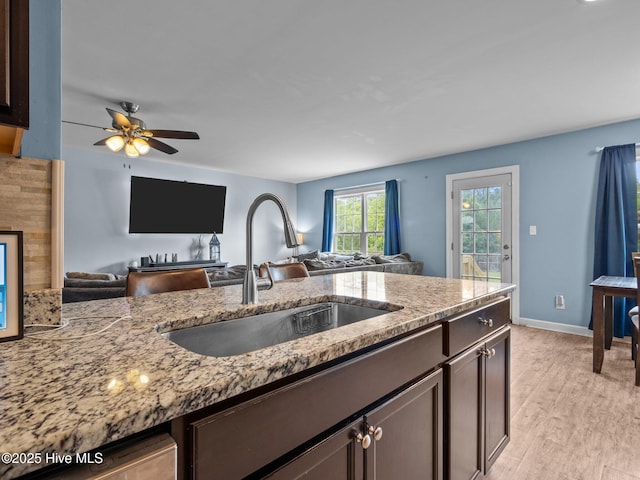 660 Riggs Rd, Hubert, NC 28539 - kitchen with a sink, open floor plan, and light stone countertops