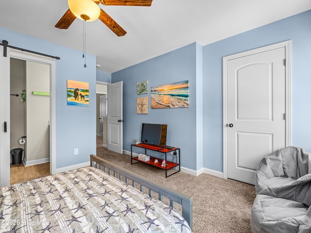 2 Catalina Cir, Swansboro, NC 28584 - bedroom featuring a barn door, baseboards, a ceiling fan, and carpet floors