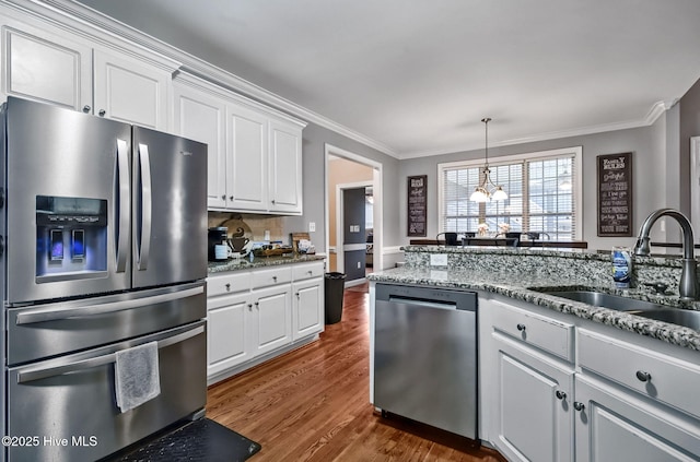 3509 Wales Pl N, Wilson, NC 27896 - kitchen featuring stainless steel appliances, a sink, ornamental molding, dark wood-style floors, and white cabinets