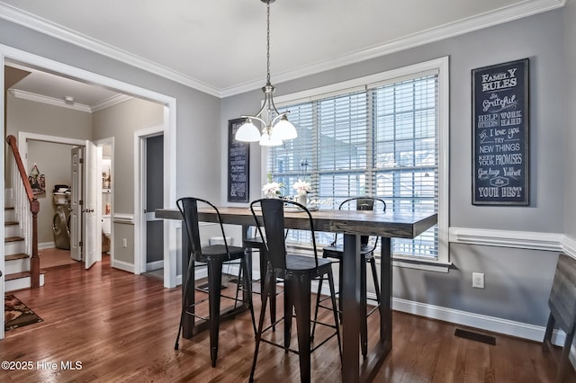 3509 Wales Pl N, Wilson, NC 27896 - dining area with a chandelier, baseboards, wood finished floors, ornamental molding, and stairs