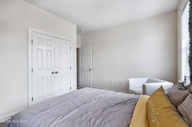 3509 Wales Pl N, Wilson, NC 27896 - bedroom featuring multiple windows, a closet, and baseboards