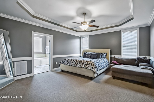 3509 Wales Pl N, Wilson, NC 27896 - carpeted bedroom with a tray ceiling, crown molding, connected bathroom, and ceiling fan