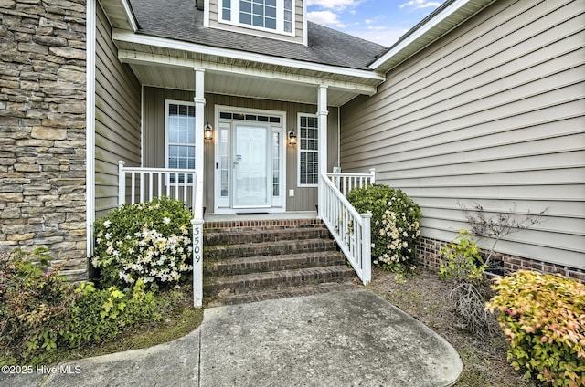 3509 Wales Pl N, Wilson, NC 27896 - view of exterior entry featuring stone siding, a shingled roof, and covered porch