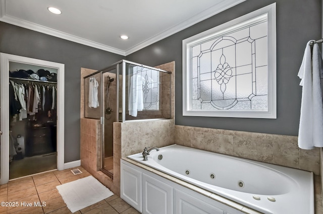 3509 Wales Pl N, Wilson, NC 27896 - bathroom with a tub with jets, a stall shower, ornamental molding, tile patterned floors, and a spacious closet