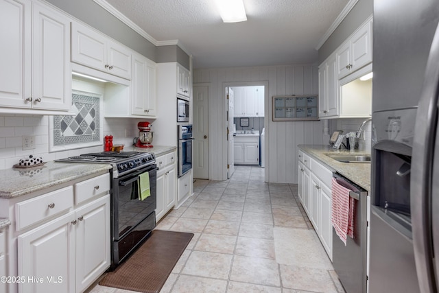 202 Forest Dr, Clinton, NC 28328 - kitchen featuring appliances with stainless steel finishes, a sink, decorative backsplash, white cabinets, and ornamental molding