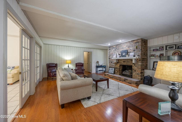 202 Forest Dr, Clinton, NC 28328 - living area featuring wood finished floors, a brick fireplace, and french doors