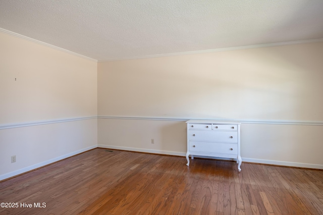 202 Forest Dr, Clinton, NC 28328 - empty room with wood finished floors, crown molding, baseboards, and a textured ceiling