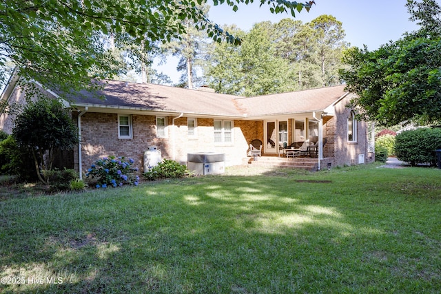 202 Forest Dr, Clinton, NC 28328 - back of house with a lawn, brick siding, and a patio
