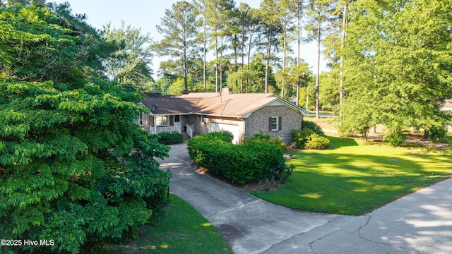 202 Forest Dr, Clinton, NC 28328 - view of front of property with a garage, a front lawn, and view of wooded area