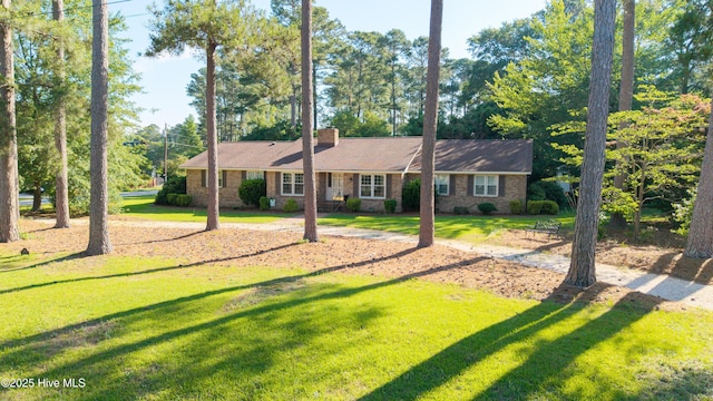 202 Forest Dr, Clinton, NC 28328 - ranch-style house with a front lawn and a chimney