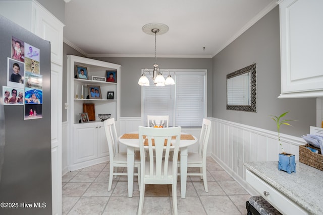 202 Forest Dr, Clinton, NC 28328 - dining space featuring a chandelier, crown molding, a wainscoted wall, and light tile patterned flooring
