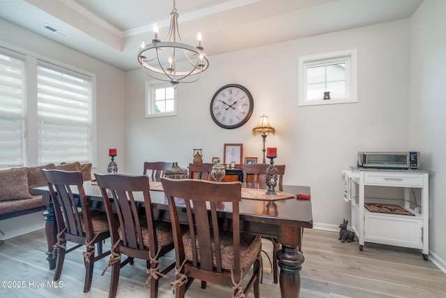 382 Sandy Brook Ct, Supply, NC 28462 - dining room featuring a chandelier, light wood-style flooring, crown molding, baseboards, and a raised ceiling