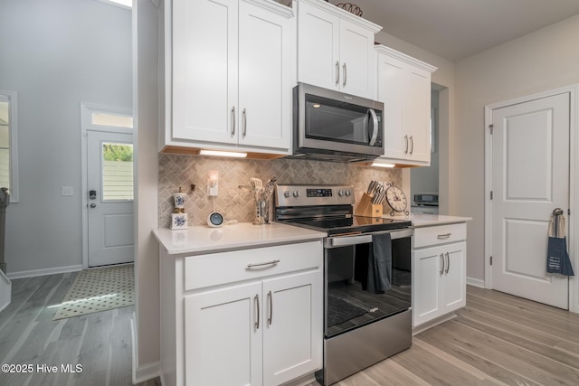 382 Sandy Brook Ct, Supply, NC 28462 - kitchen with appliances with stainless steel finishes, light wood-type flooring, light countertops, and decorative backsplash
