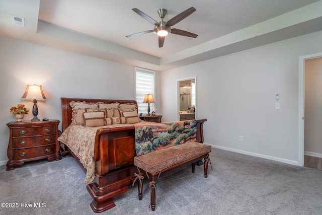 382 Sandy Brook Ct, Supply, NC 28462 - carpeted bedroom with baseboards, a ceiling fan, ensuite bathroom, and a tray ceiling