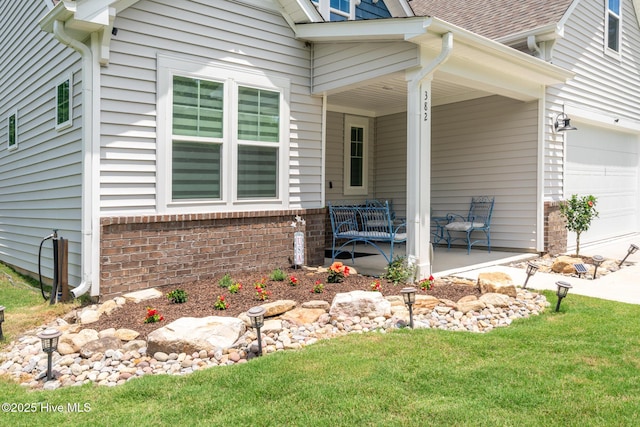 382 Sandy Brook Ct, Supply, NC 28462 - view of home's exterior featuring covered porch, a lawn, and an attached garage