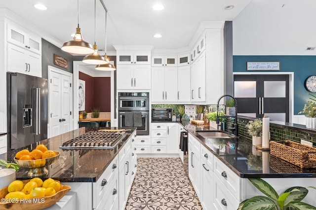 3108 Rivendell Pl, Wilmington, NC 28411 - kitchen with appliances with stainless steel finishes, decorative backsplash, white cabinetry, dark stone counters, and recessed lighting