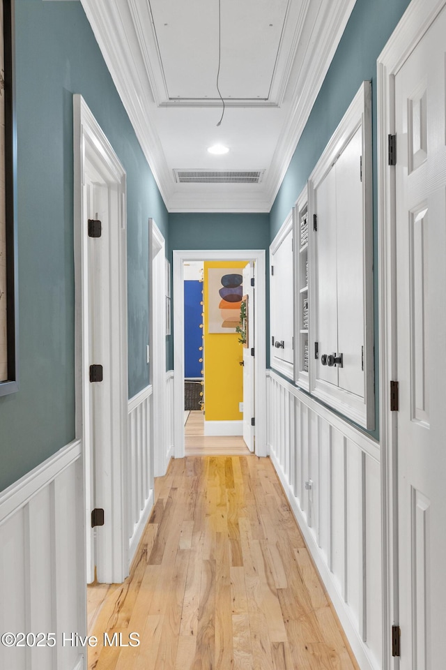 3108 Rivendell Pl, Wilmington, NC 28411 - hall featuring attic access, wainscoting, crown molding, light wood-style flooring, and a decorative wall