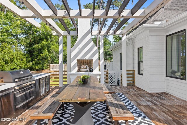 3108 Rivendell Pl, Wilmington, NC 28411 - view of patio / terrace featuring outdoor dining area, a deck, an outdoor kitchen, a fireplace with raised hearth, and a pergola