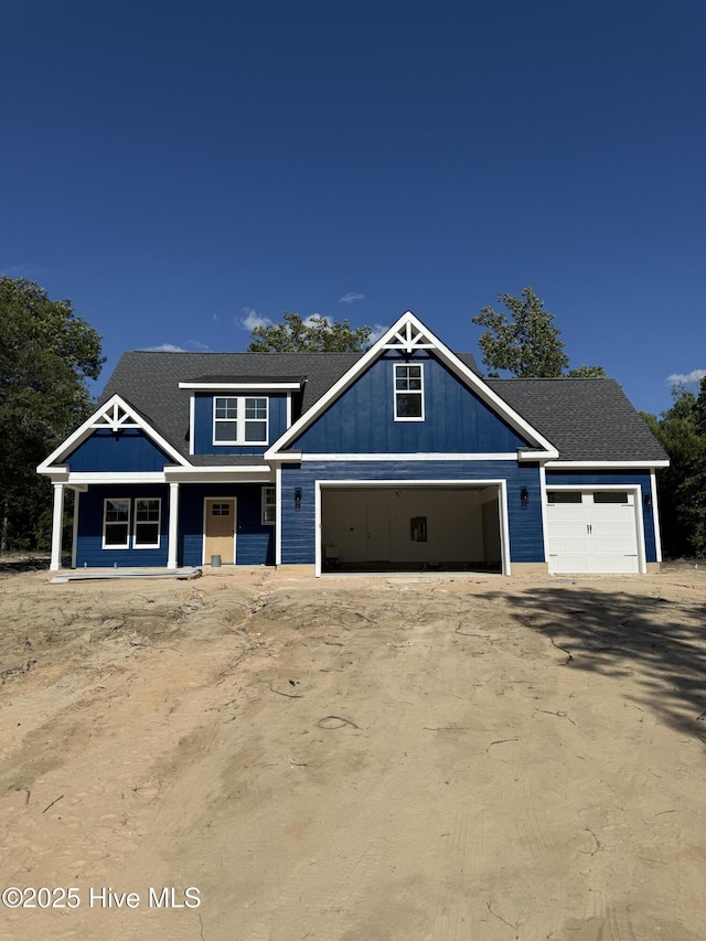 520 Harrow Dr, Carthage, NC 28327 - craftsman inspired home featuring a garage, driveway, a porch, and board and batten siding