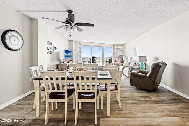 2000 New River Inlet Rd Unit 1208, North Topsail Beach, NC 28460 - dining area with a textured ceiling, a ceiling fan, wood finished floors, and baseboards