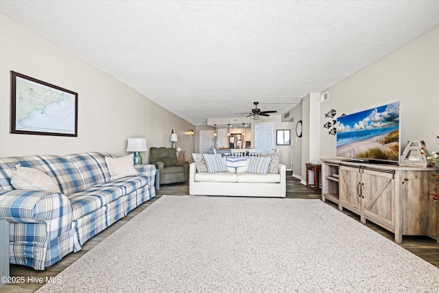 2000 New River Inlet Rd Unit 1208, North Topsail Beach, NC 28460 - living area with dark wood-style flooring, ceiling fan, and a textured ceiling