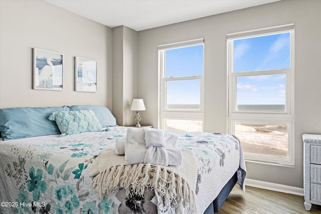 2000 New River Inlet Rd Unit 1208, North Topsail Beach, NC 28460 - bedroom featuring wood finished floors and baseboards