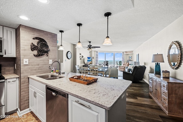 2000 New River Inlet Rd Unit 1208, North Topsail Beach, NC 28460 - kitchen with appliances with stainless steel finishes, a sink, a textured ceiling, ceiling fan, and white cabinets