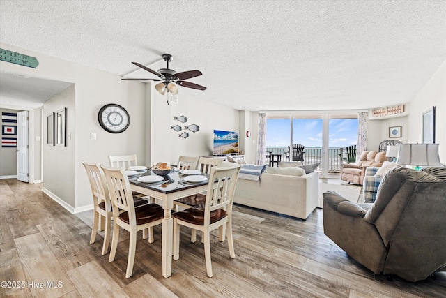 2000 New River Inlet Rd Unit 1208, North Topsail Beach, NC 28460 - dining room with a textured ceiling, light wood-style floors, and ceiling fan
