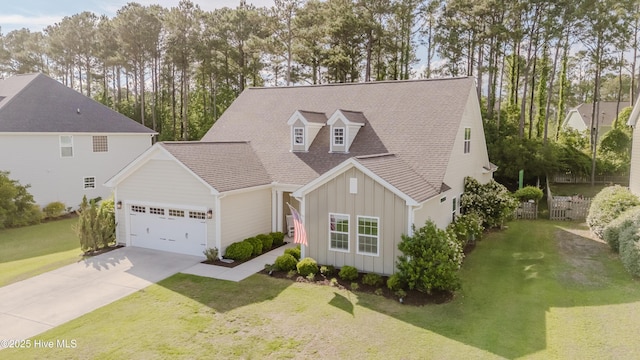 411 Canvasback Ln, Sneads Ferry, NC 28460 - view of front facade featuring board and batten siding, an attached garage, driveway, a front lawn, and a shingled roof