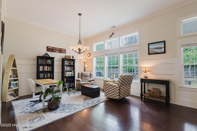 411 Canvasback Ln, Sneads Ferry, NC 28460 - living area featuring a decorative wall, ornamental molding, a chandelier, hardwood / wood-style floors, and a wainscoted wall