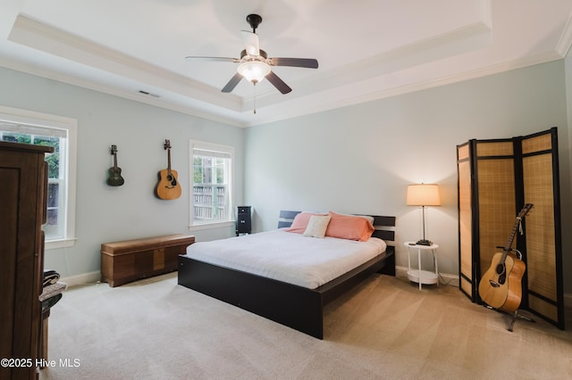 411 Canvasback Ln, Sneads Ferry, NC 28460 - bedroom featuring a tray ceiling, crown molding, carpet flooring, a ceiling fan, and baseboards